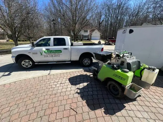 Field of Dreams Lawn Care branded truck and spreader equipment ready for foundation treatment
