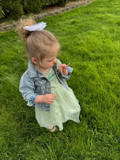 Child enjoying a healthy Northeast Ohio lawn after seasonal turf care