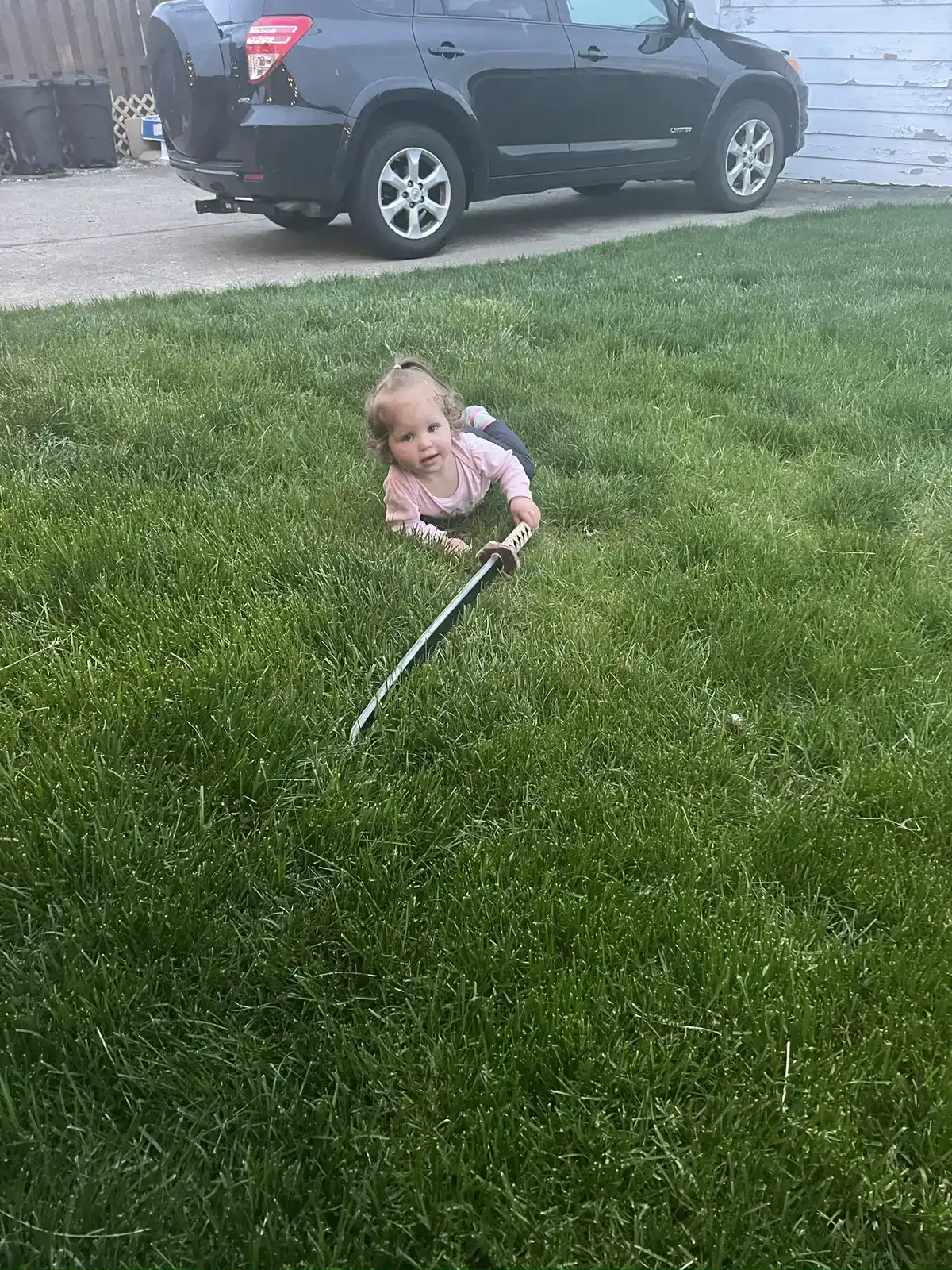 Toddler playing safely on a treated residential lawn in Northeast Ohio